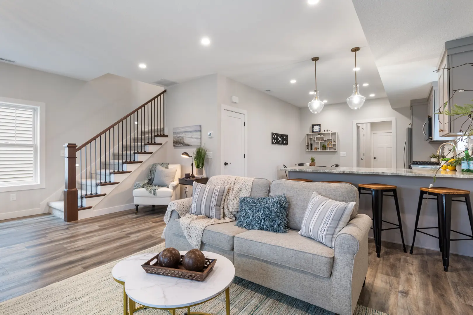 panoramic view of the living room with fireplace and kitchen in a new construction home in The Grove, Warsaw, Indiana